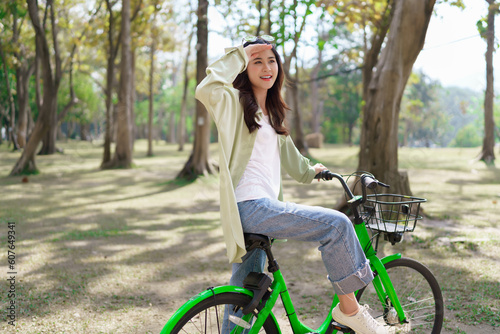 Women watching nature view with happiness while cycling for exercise with healthy lifestyle in park