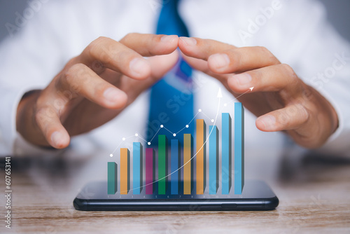 Businessman with smartphone access stock market graph financial profit stock development. Goal business success strategy chart target. Business finance marketing and investment.