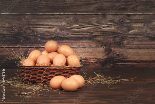 Fresh eggs in a basket beautifully placed on the wooden floor.