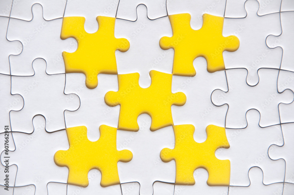 Top view of missing jigsaw puzzle with customizable space for text. Copy space with yellow background Top view of missing jigsaw puzzle with customizable space for text. Copy space with yellow background