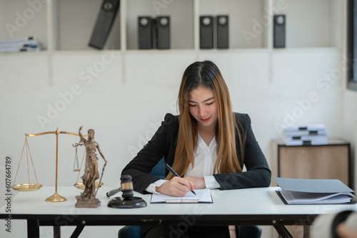 Lawyers Asiawoman   having through online Concepts  of Legal services at the law office. photo