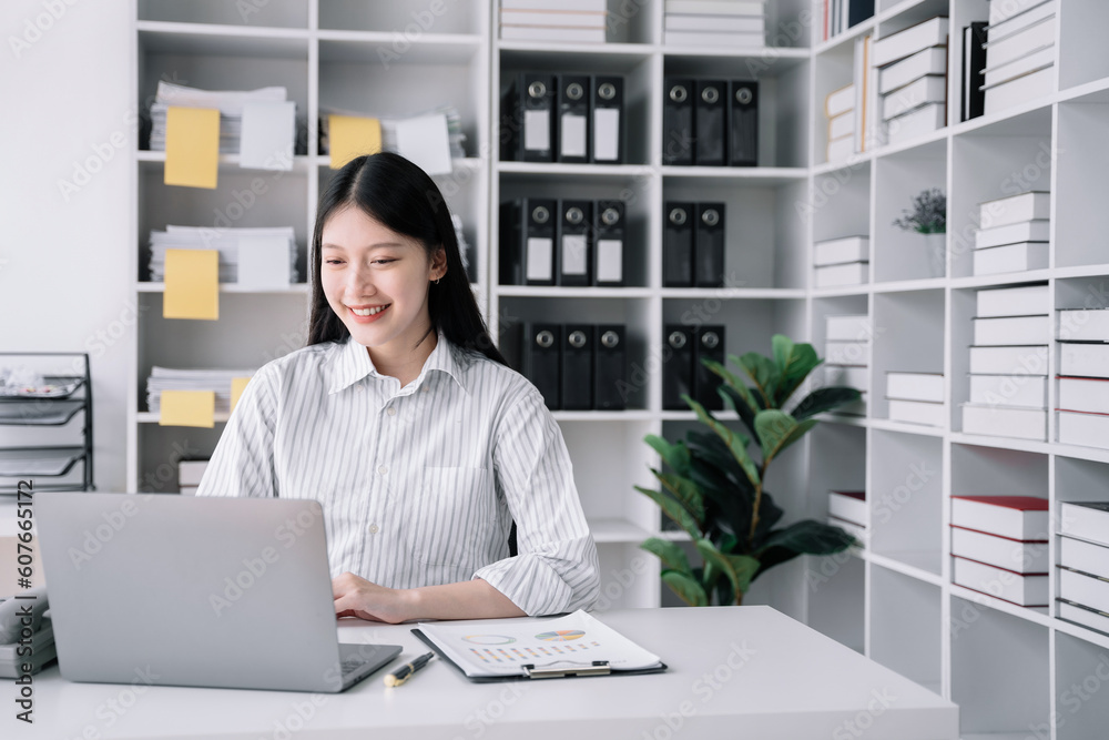 Business women hand working with laptop computer with documents on office desk in modern office.