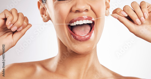 Φωτογραφία Smile, dental and woman flossing teeth in studio for hygiene, wellness or fresh breath on grey background