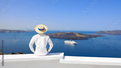 Summer blue trend with young man in hat at happy freedom lifestyle in Aegean sea mediterranean at Santorini,greece.