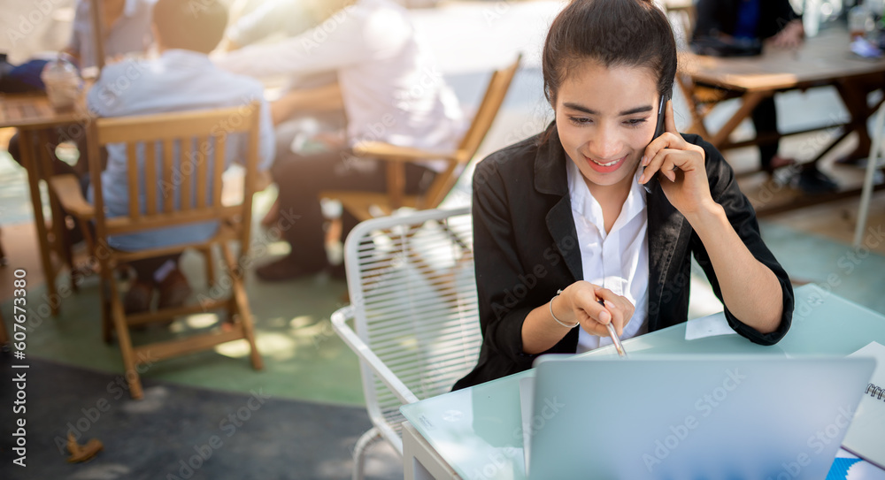 Busy young business woman working in coffee shop