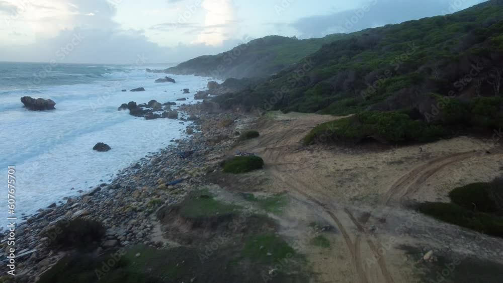 Iconic ocean coastline after sunset, aerial drone fly backward view Iconic ocean coastline after sunset, aerial drone fly backward view