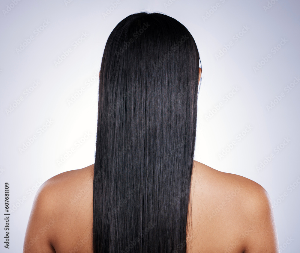 Fototapeta premium Back, hair care and woman with shine, salon and confident girl against a studio background. Female person, cosmetics or model with treatment, grooming or healthy scalp with luxury, glow and self care