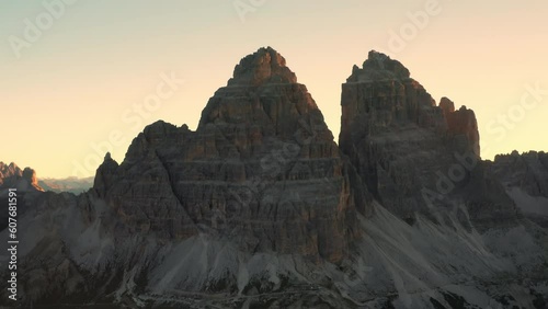 As the sun ascends, the mountainous landscape unveils the grandeur of the majestic Three Peaks of Lavaredo photo