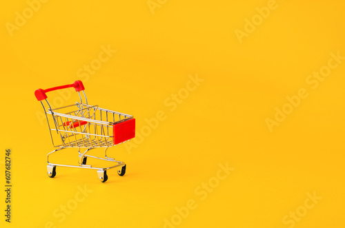 Shopping Cart or Trolley on Yellow Background, Shopping Concept