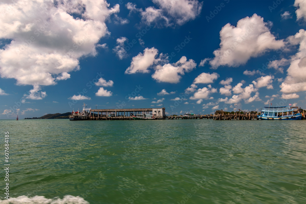 Tranquil Oasis: Rayong, Thailand's pier in the Gulf of Thailand, surrounded by fishing and tourist boats during Island Hopping. Tranquil Oasis: Rayong, Thailand's pier in the Gulf of Thailand, surrounded by fishing and tourist boats during Island Hopping.