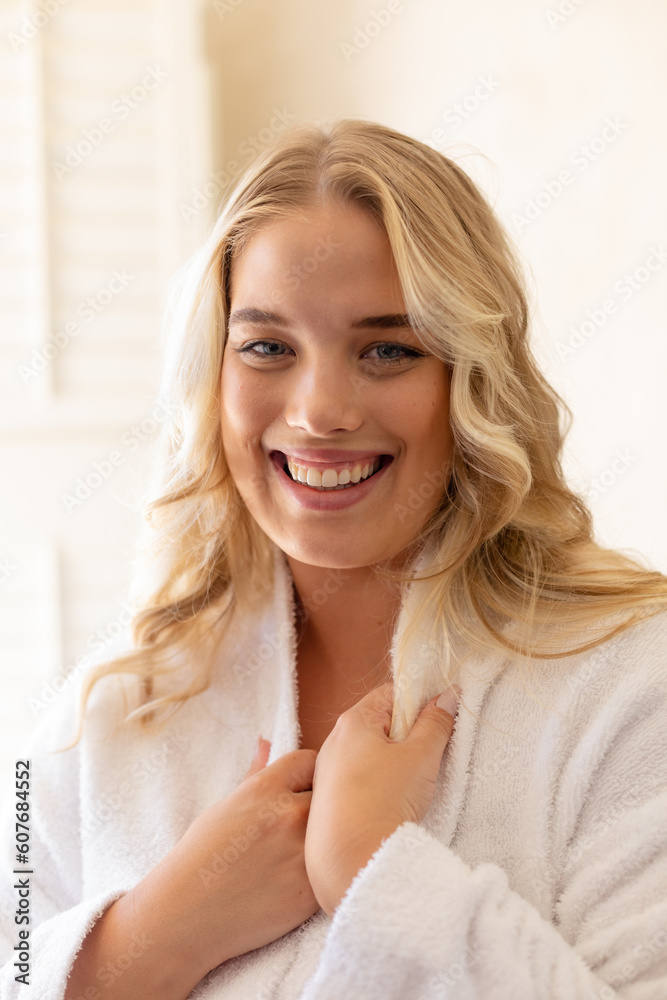 Closeup portrait of smiling plus size beautiful caucasian young woman dressed in white bathrobe Closeup portrait of smiling plus size beautiful caucasian young woman dressed in white bathrobe