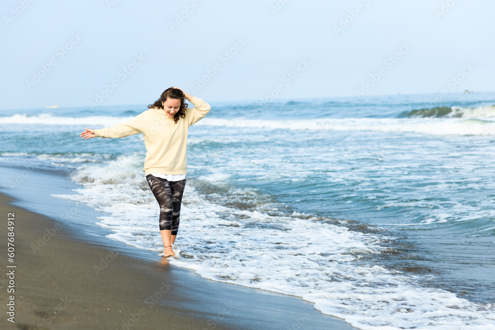 Sporty young woman enjoying sunlight and day dreaming