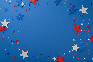 Experience the joy of Independence Day with this top-down view: glimmering stars and confetti, artfully arranged on a blue surface with a blank circle for text or promotion