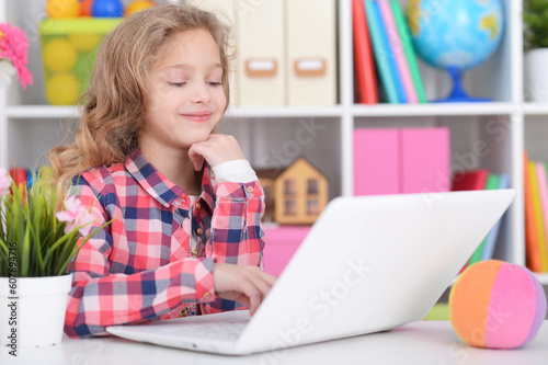 little girl using modern laptop