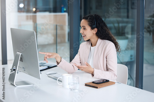 Call center, video call and woman in customer support on computer with headset for consulting. Telemarketing, communication and female worker point to pc screen for crm service, help desk and contact