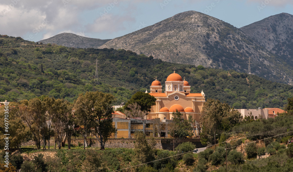 Neopoli, Eastern Crete, Greece. 2023. Greek Orthodox church with a backdrop of mountains in eastern Crete, Greece.
