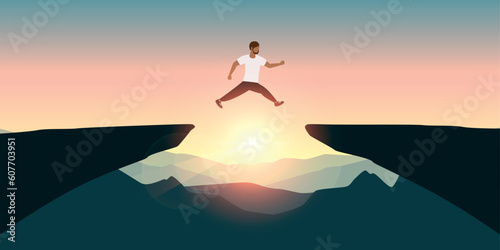 sporty man successful jumping over a cliff on mountain landscape