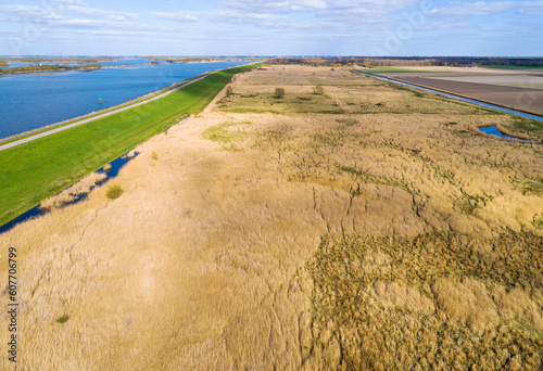Aerial view of open nature area with reedland and dike along lake Ketelmeer, Roggebotveld, Dronten, Flevoland, Netherlands. photo