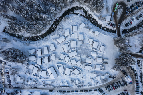 Aerial view of houses along the frozen Vieze river with snow in wintertime, Champery, Valais, Switzerland. photo