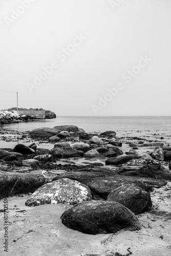 Black And White Beach Scene With Rocky Outcrops And No People photo