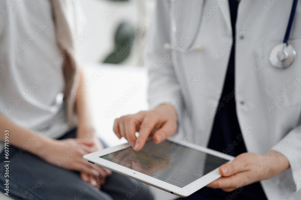 Doctor and child patient. The doctor is using tablet computer and is ready to examine the boy. The concept of ideal health in medicine. Doctor and child patient. The doctor is using tablet computer and is ready to examine the boy. The concept of ideal health in medicine.