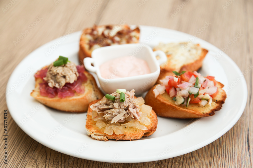 5 kinds of bruschetta served with Belgian Andalouse sauce 5 kinds of bruschetta served with Belgian Andalouse sauce