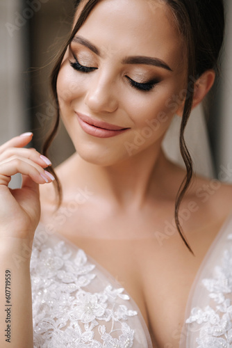 Close-up portrait of elegant woman in luxury wedding dress. Bride morning concept photo