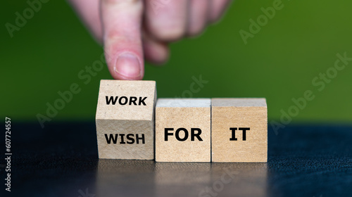 Hand turns wooden cube and changes the expression 'wish for it' to 'work for it'.