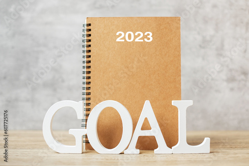 2024 Happy New Year with notebook and wooden number. goal, countdown, Resolution, Plan, Action and Mission Concept