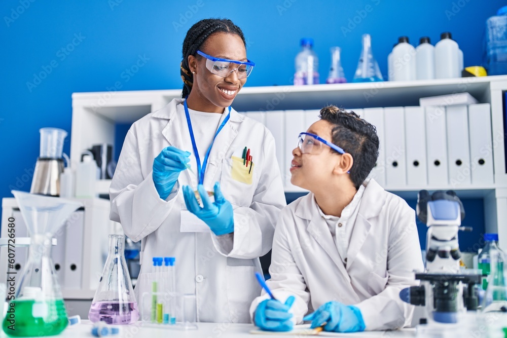 African american mother and son scientists smiling confident working laboratory African american mother and son scientists smiling confident working laboratory
