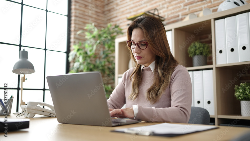 Young beautiful hispanic woman business worker using laptop working at office Young beautiful hispanic woman business worker using laptop working at office