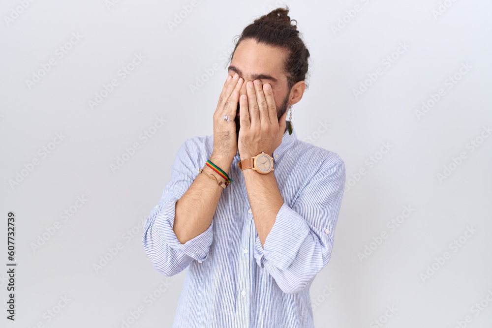 Hispanic man with beard wearing casual shirt rubbing eyes for fatigue and headache, sleepy and tired expression. vision problem Hispanic man with beard wearing casual shirt rubbing eyes for fatigue and headache, sleepy and tired expression. vision problem