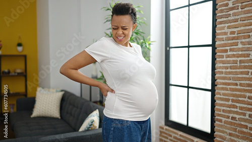 Young pregnant woman suffering for backache at home