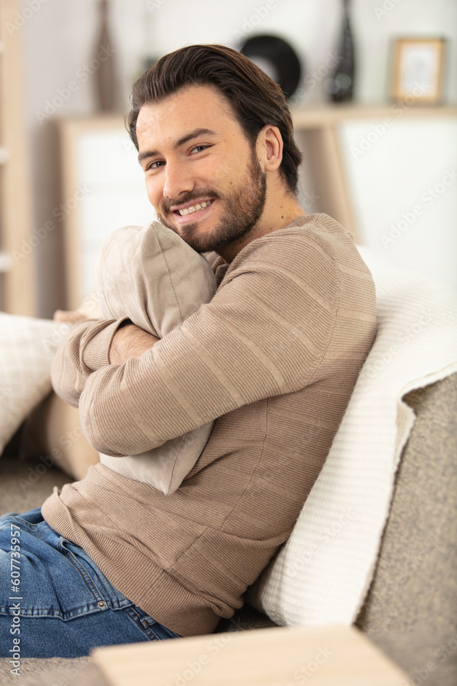 attractive smart young man sitting in the living room attractive smart young man sitting in the living room