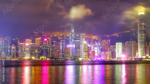 Beautiful scenic night view skyline of Hong Kong Victoria Harbor with illuminated lights from modern building architecture  