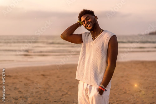 Photography Portrait of black ethnicity model enjoying summer vacation by the sea smiling an