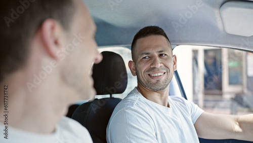 Two men couple driving car speaking at street