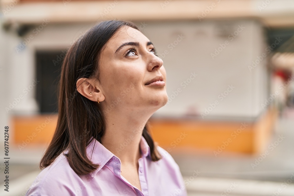 Young hispanic woman smiling confident looking to the sky at street Young hispanic woman smiling confident looking to the sky at street