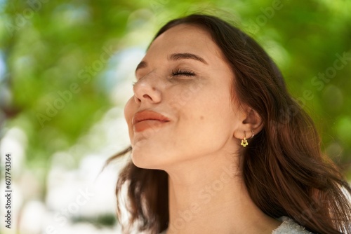 Young woman smiling confident breathing at park