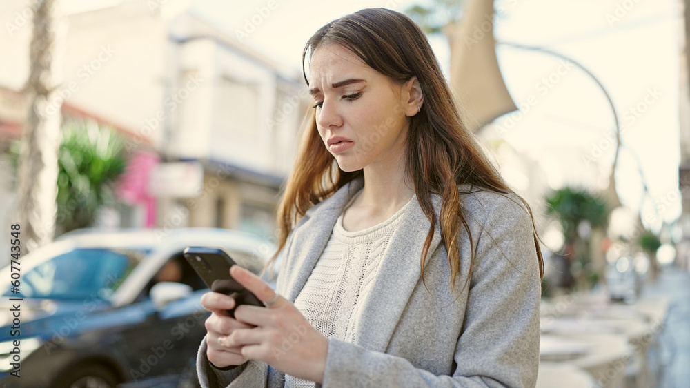 Young hispanic woman using smartphone looking upset at street Young hispanic woman using smartphone looking upset at street