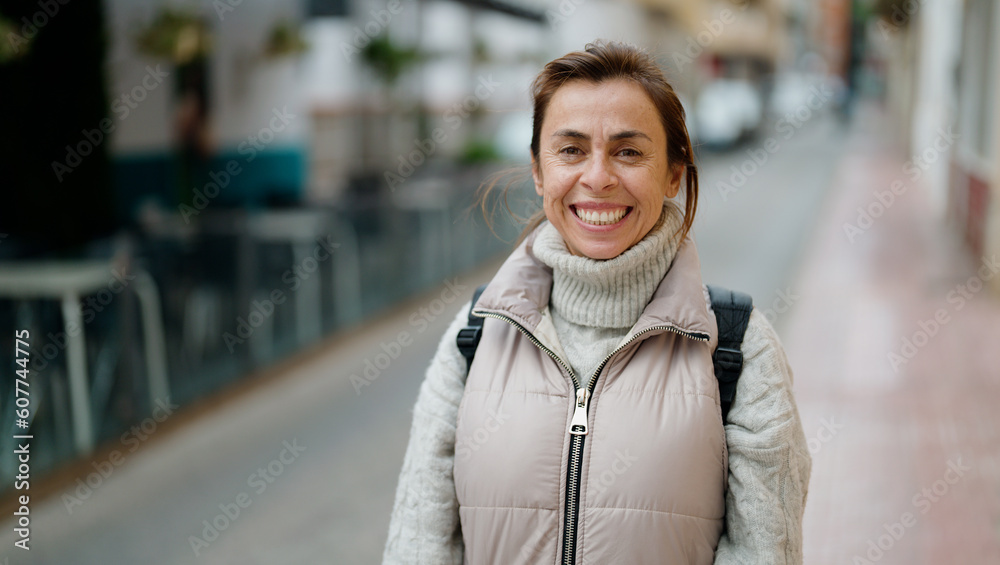 Fototapeta premium Middle age hispanic woman smiling confident standing at street