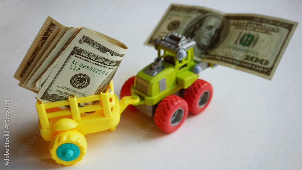Fototapeta premium Toy truck with money. Lots of dollars. 
