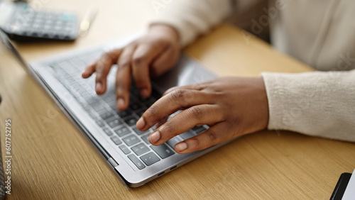 African american woman using laptop at office