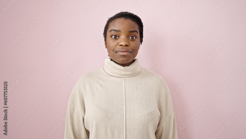 African american woman standing with relaxed expression over isolated pink background African american woman standing with relaxed expression over isolated pink background