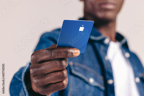 Man in a denim jacket pays with a credit card, taking advantage of NFC technology photo