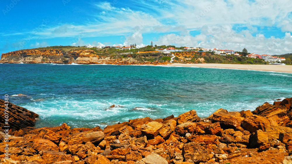 Obraz premium Beautiful sandy beach on summer sunny day with azure water. Aerial view: beach with white sand and blue water. Drone view of scenic nature in Portugal. Beautiful seascape in Europe