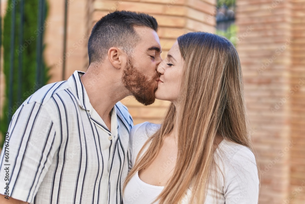 Man and woman couple hugging each other kissing at street Man and woman couple hugging each other kissing at street