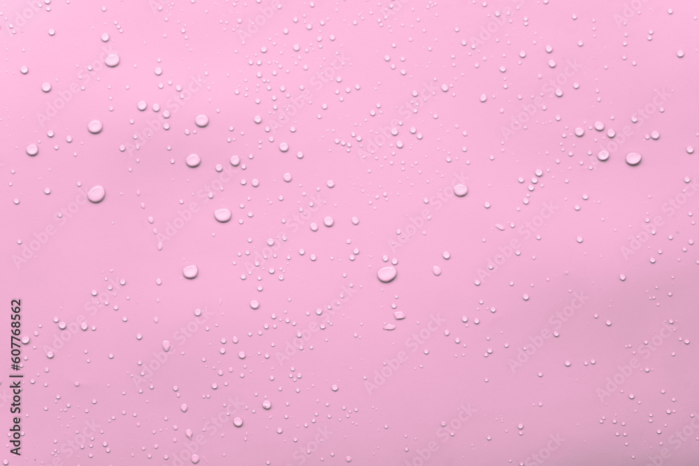Water or rain drops on pink background 