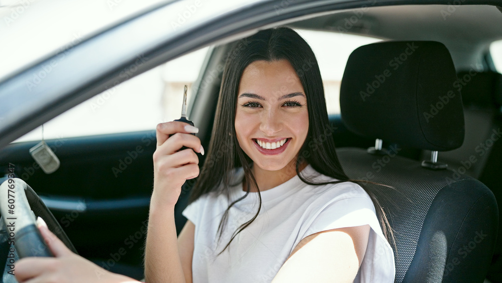 Young beautiful hispanic woman smiling confident holding key of new car at street Young beautiful hispanic woman smiling confident holding key of new car at street