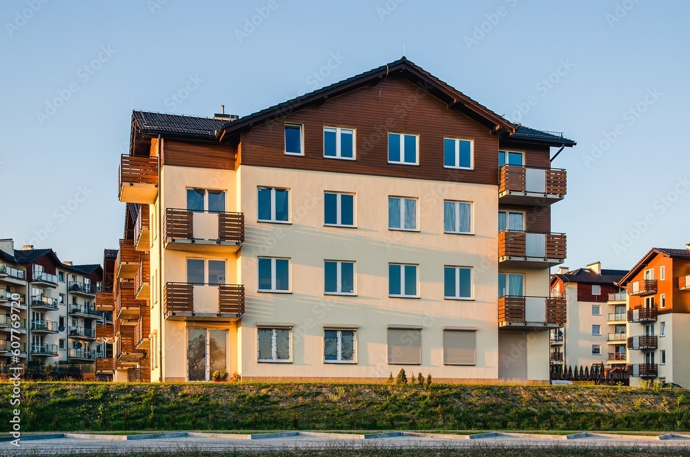New housing estates in Tychy City, Poland. Public view of newly built block of flats in the green area.